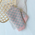 Pink and grey checkerboard knitted gloves with ribbed cuffs on a natural background - Grid Pink