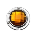 Close-up of a foldable purse hook with a polished silver ring and amber crystal gemstone - Brown
