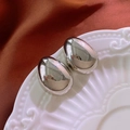 Polished silver metal oval stud earrings on white ceramic plate with red velvet fabric - Alloy (925 Silver Needle) / Silver
