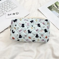 Close-up of light blue quilted makeup bag with cartoon cat patterns and a sturdy zipper - Black Cat Dots (Light Blue)