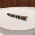 Detail of elegant gold alloy hair clip with colorful gemstones on a white pedestal - Round Mixed Color D