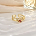 Detail of gold open ring featuring a red star gemstone and shimmering zircon pavé - Red Star Double Layer (JZ0128)