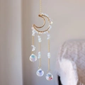 Detail of moon-shaped suncatcher with crushed white crystals and hanging faceted prisms - Opal