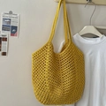 Hollow cotton woven shoulder bag in vibrant yellow hanging on a minimalist wall - Yellow