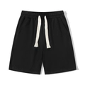 Classic black drawstring sports shorts with thick white cords and elastic waist in flat lay - M / Black