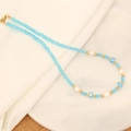 Detail of blue crystal bead necklace with white pearls and gold accents on white cloth - Blue Crystal Pearl Style (2#)