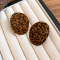 Macro detail of flocking leopard print round earrings resting in a soft jewelry box - Brown Oval Leopard Style (17#)