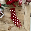 Thick red Christmas sock with white polka dots on a festive wooden surface - Red with White Polka Dots