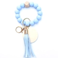 Detail of light blue silicone beads keychain with wooden hexagon bead and leather tassel - Light Blue