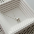 Macro shot of a minimalist 18k gold plated necklace with a cubic zirconia pendant - Silver