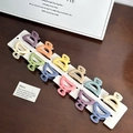 Set of 12 matte macaron color mini hair claw clips neatly arranged on a wooden table - Set-7 / Random Color
