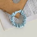 Light blue ruched satin hair scrunchie with glossy finish for elegant ponytails - Cyan