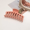 Close-up of a large matte coral hair claw clip on an aesthetic background with a mirror - Keel / Orange Pink