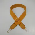Close-up of ginger yellow adjustable canvas strap with gold metal hooks and PU leather ends - Yellow