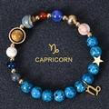 Detailed macro view of Capricorn zodiac bracelet with blue natural stones and gold star charms - Capricorn