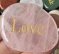 Pink rose quartz heart stone engraved with gold Love lettering held in hand - Rose Quartz