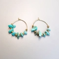 Detailed macro view of Bohemian gold hoop earrings featuring turquoise stone beads - Turquoise
