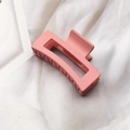 Elegant matte pink rectangular hair claw clip for women on white fabric background - Pink
