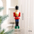 Nutcracker Christmas tree ornament in red uniform on green gift box with measurements - Nutcracker Soldier