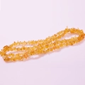 DIY necklace crafted with irregular natural yellow crystal agate stones on pink background - Citrine
