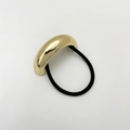 Close-up of golden metal textured accent on black elastic hair tie for women - Eco-friendly Style B Gold