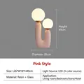 Modern U-shaped pink resin table lamp with two white glass globes in minimalist style - Pink