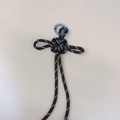 Dark brown woven lanyard keychain with white reflective dots and silver metal spring ring - Tan