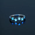 Detailed close-up of luminous star ring with glowing blue accents on a silver band - US 8 / NY815 Star