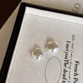 Elegant matte silver C-shaped hoop earrings presented in a jewelry display tray - Matte Silver Hoop (A1970 Matte Silver)