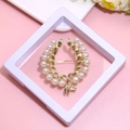 Elegant gold wreath brooch with white pearls on a soft pink background in a white display box - XZ155-Pearl Wreath-Boxed