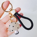 Detail showing crystal mushroom keychain with black white stripes and braided leather strap - Mushroom + Heart Strap / White