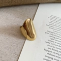 Artistic close-up of wide gold irregular ring on rustic linen and text background - Irregular Wide Streamline / No.11 Ring-Gold