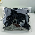 Detail of multi-pack colorful elastic hair bands for babies in a clear sealed bag - Black