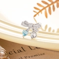 Elegant bow stud earring with light blue heart gemstone and sparkling crystals - Light Sea Blue (Single Piece)