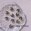 Macro detail of 10x12mm resin Halloween castle nail art charms in black and yellow - YD-703# Yellow Castle