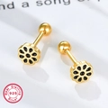 Macro shot of black enamel flower stud earrings in 925 sterling silver with gold finish - Gold Black