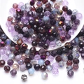 Close-up of faceted crystal glass beads in purple and black for DIY jewelry making - Purple Series