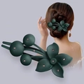 Dark green matte flower hair claw with small rhinestones shown on a model - Dark Green