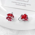 Macro shot of two red enamel rose charms with silver metal rings on a white dish - Red Rose / #5 Single Price