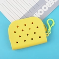 Compact yellow perforated silicone coin purse with matching hook on a blue background - Yellow