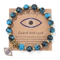 Detail of blue turquoise beads with an evil eye pendant on a display backing card - 19cm / Black Line Blue Turquoise