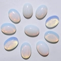 Set of 9 oval opal loose gemstones featuring milky white translucency and play-of-color - Opalite (Synthetic)