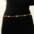 Detail of gold chain belt with faux pearls on black dress for elegant styling - Artificial Pearl Embellished Style (M-044)