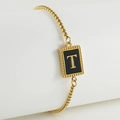 Adjustable gold stainless steel bracelet featuring a black shell pendant with letter T - T-Black