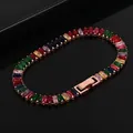 Detailed macro view of rainbow tennis bracelet with colorful rectangular crystals and fold-over clasp - Rose Gold + Multicolored Stones