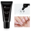 Macro view of transparent solid nail tip glue texture and the 30ml black squeeze tube - 30ml