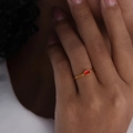 Minimalist gold titanium ring with a red oval zircon stone shown on a finger - US 6 / Gold Red Glass