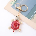 Macro detail of a red crystal turtle keychain with gold hardware and sparkling rhinestones - Turtle 6 (Red)