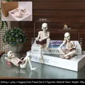 Three-piece resin skeleton reading sculptures in antique white bone finish - Reading Ornament Three-Piece Set