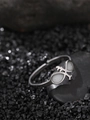 Macro shot of silver adjustable metal ring with white stones on black volcanic rocks - Figure 8 Loop Style (NR304)